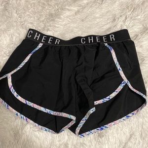 Black Athletic Shorts That Say Cheer On Waist Band And Have Multicolored Lining
